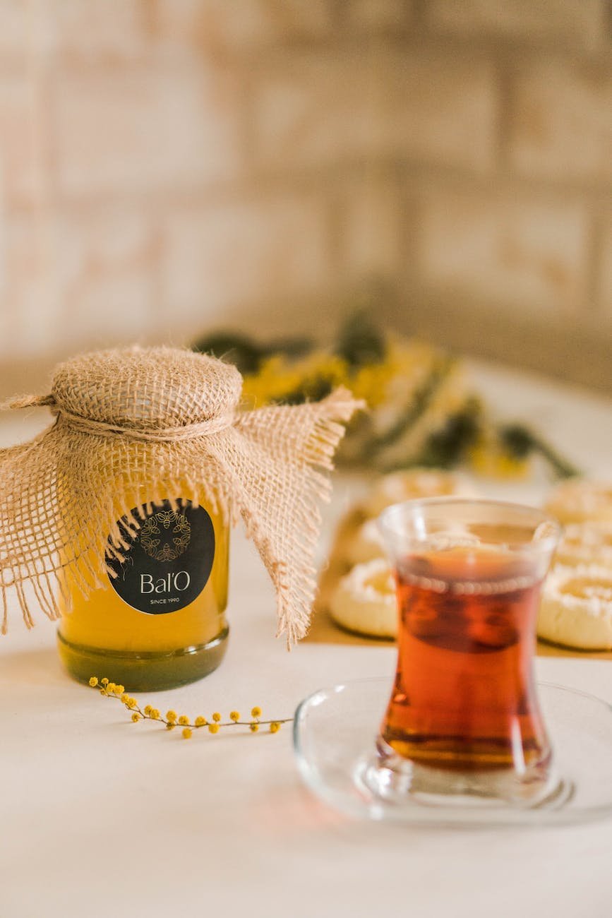 turkish tea in a glass and a jar of honey