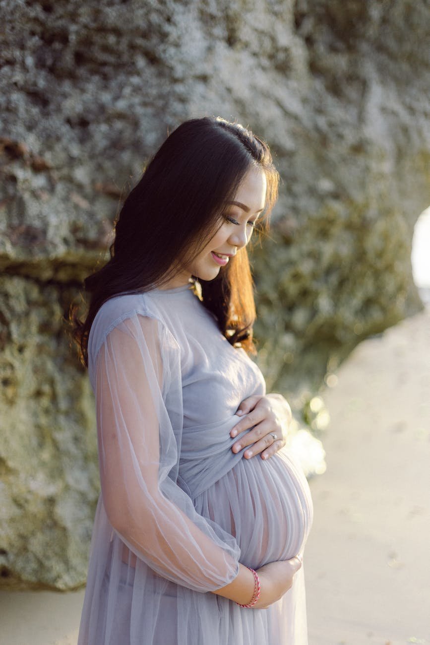 photo of pregnant woman wearing purple dress