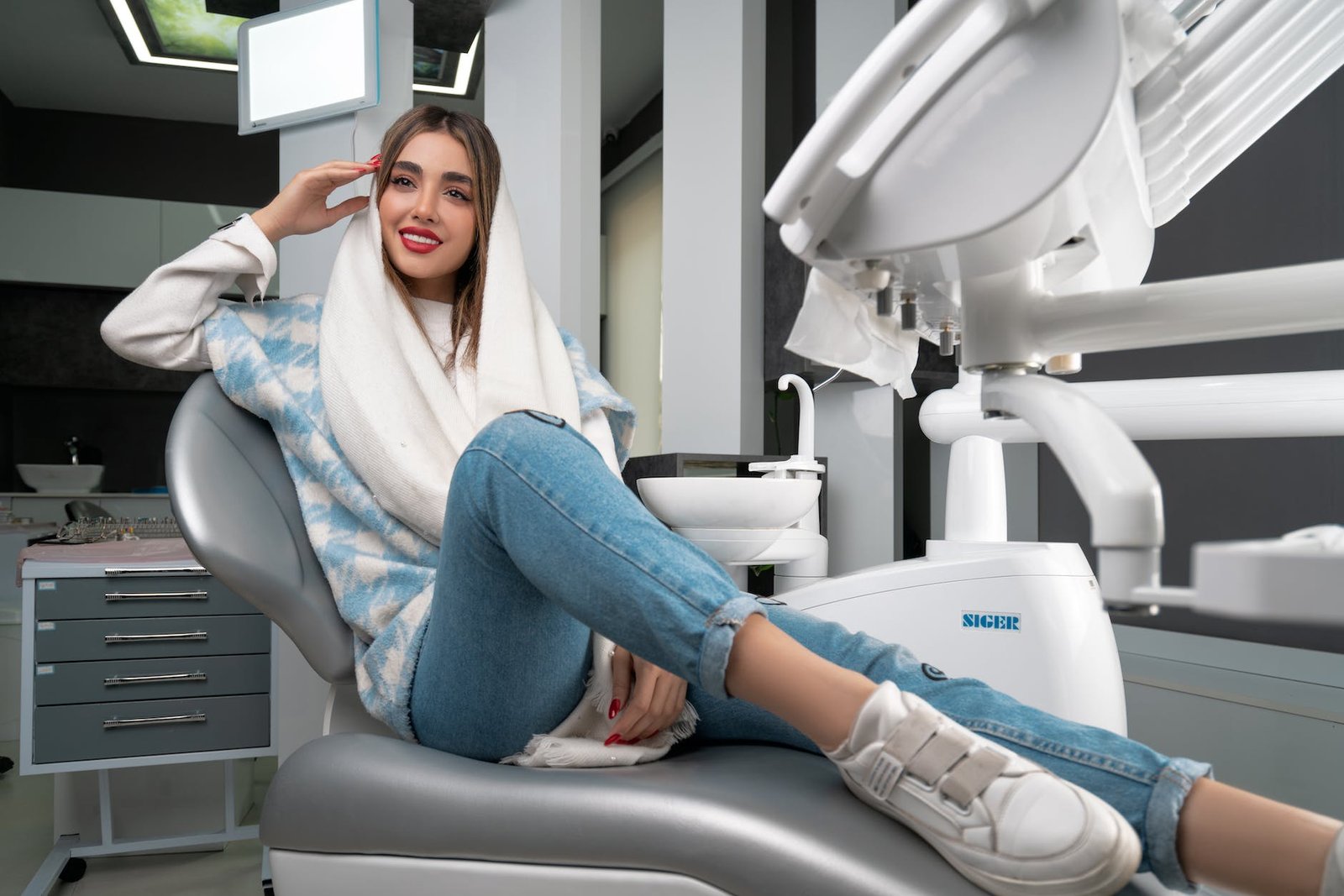 a woman sitting on a dental chair