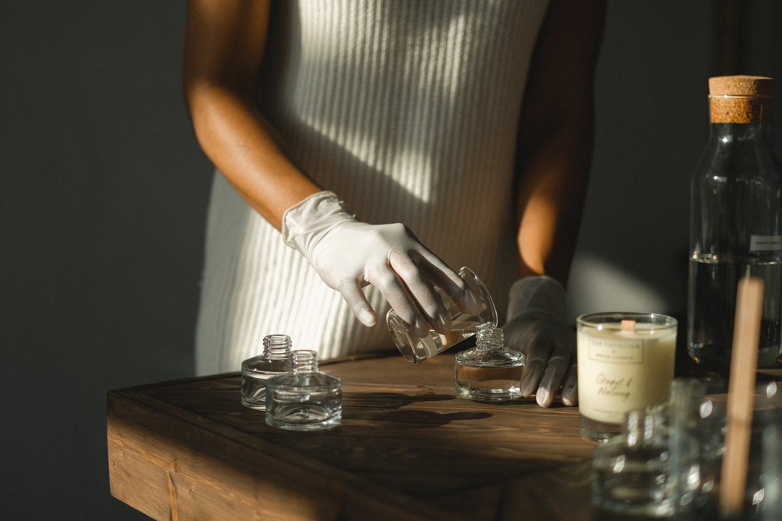 crop ethnic woman creating aromatic incense with essential oils